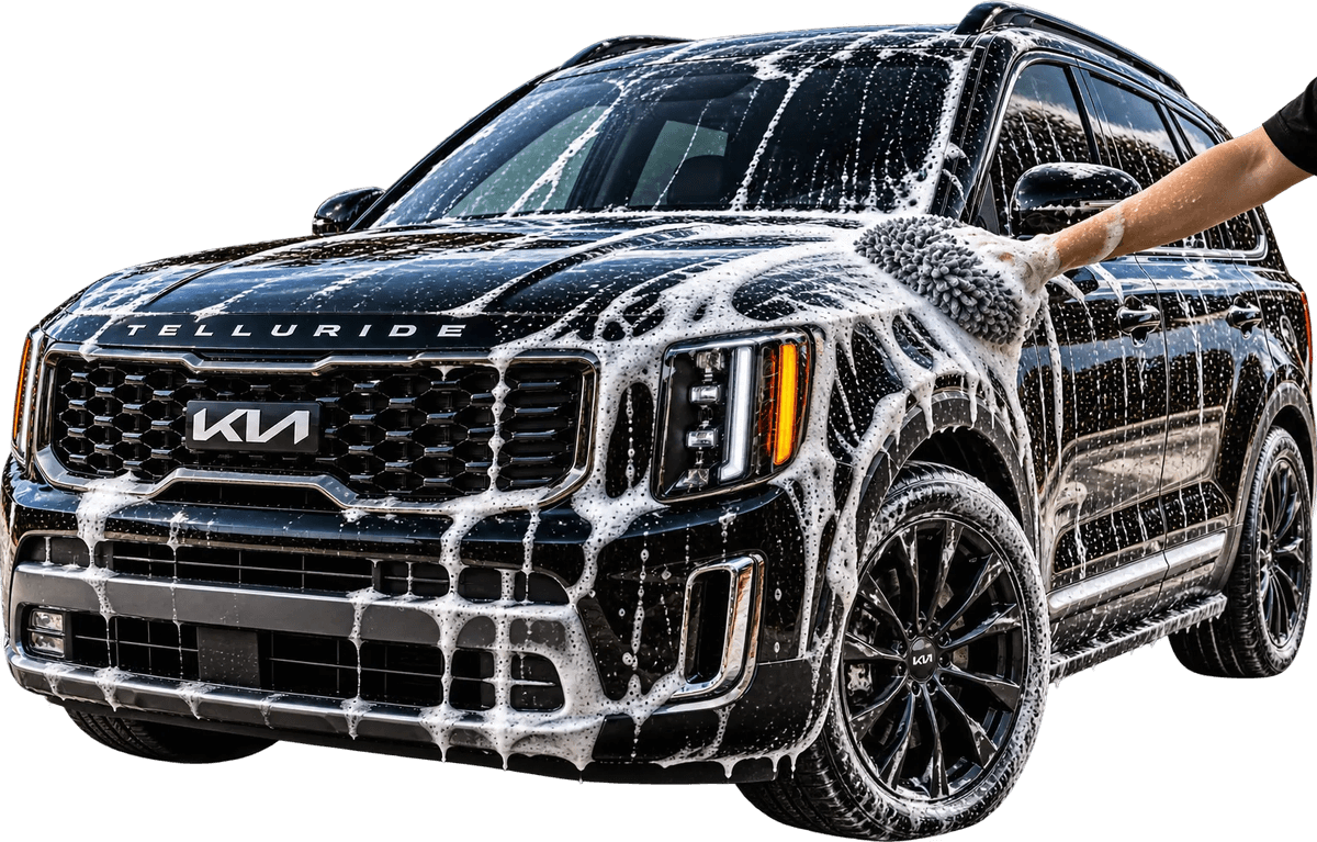 Hand wash with a microfiber mitt on a foamed black Kia Telluride